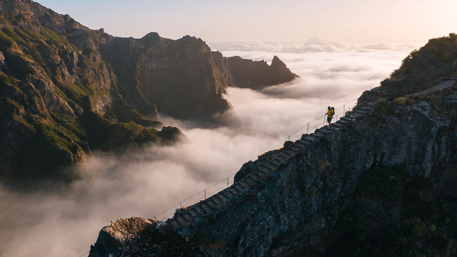 Man hiking down steps on a mountain