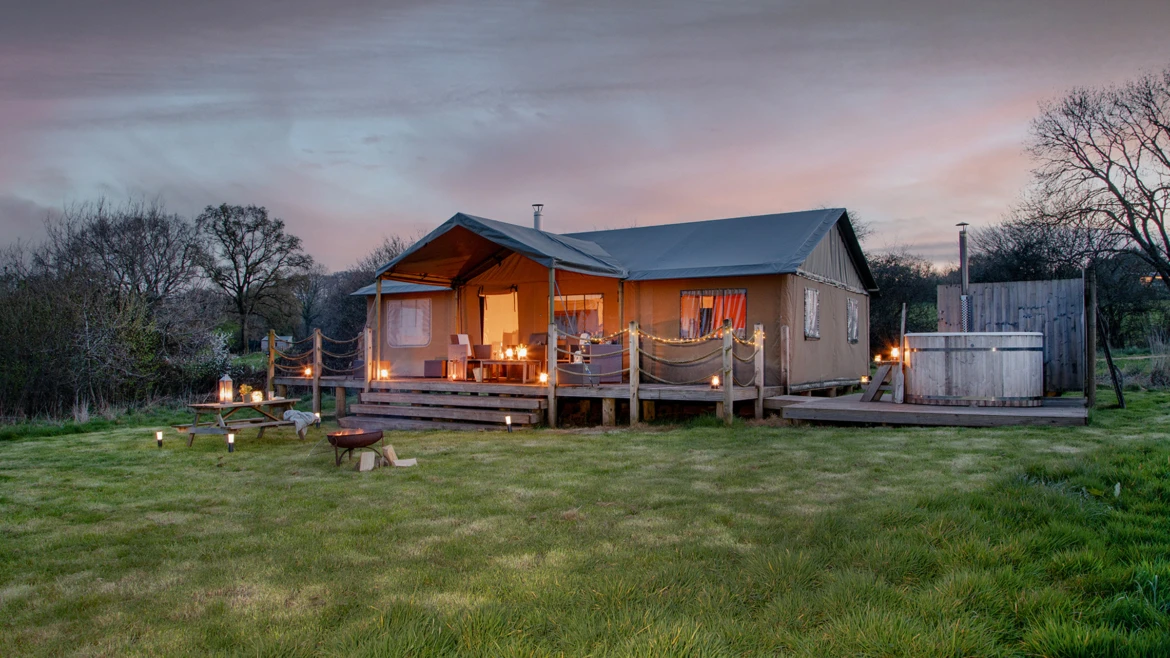 Glamping hut with hot tub in a field