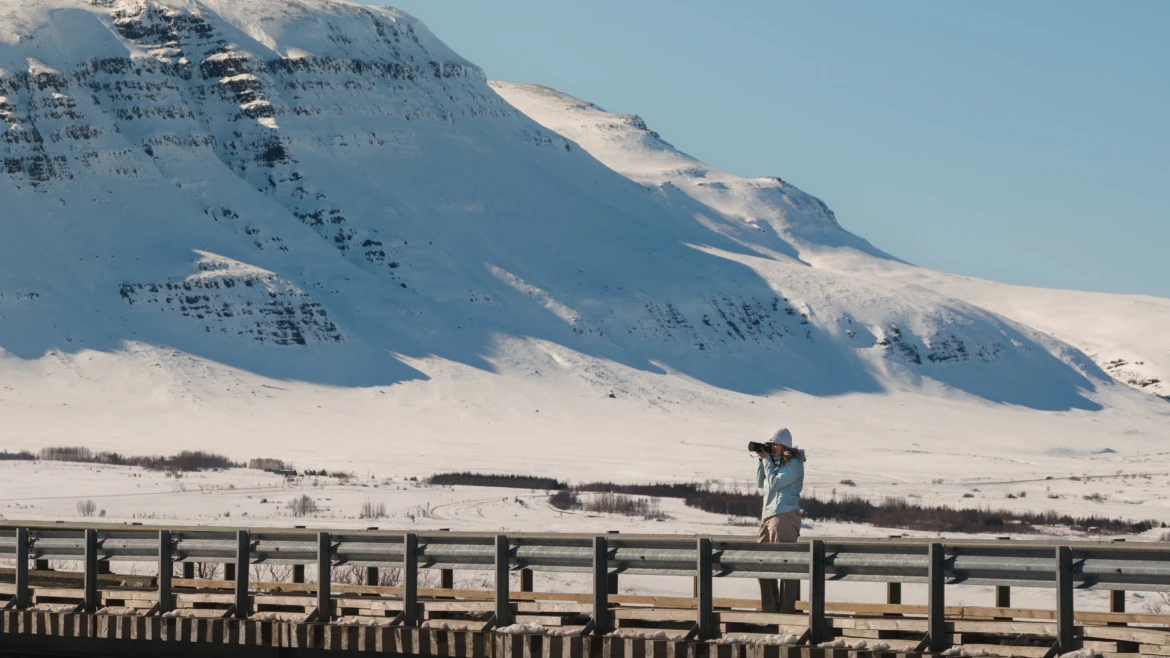 Woman taking photos in a snowy landscape