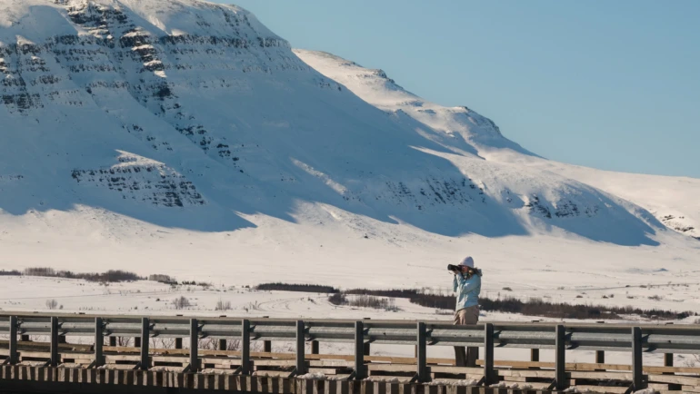 Woman taking photos in a snowy landscape